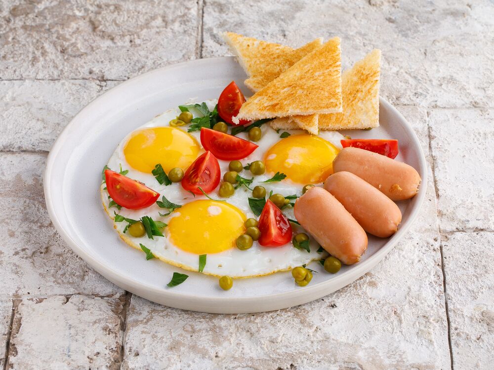 Homemade fried eggs with sausages