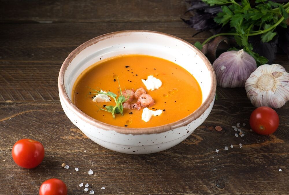 Tomato soup with soft cheese and shrimp