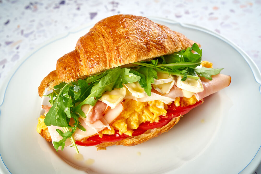 Croissant with Tambov ham, Brie cheese and scramble