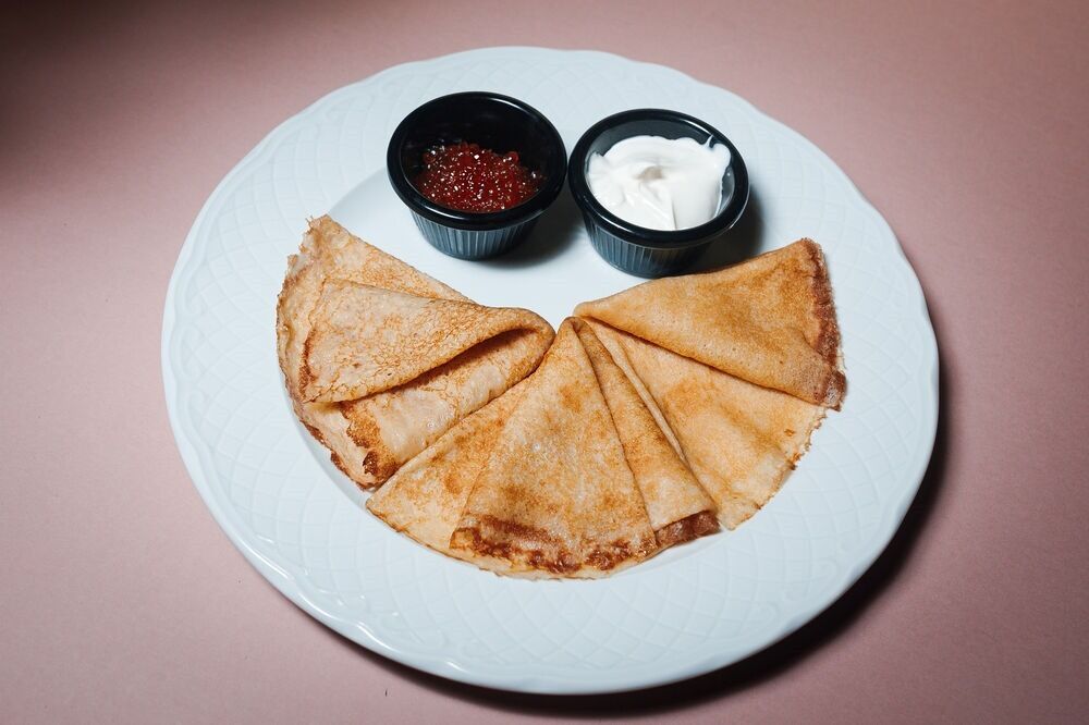 Pancakes with red caviar and sour cream