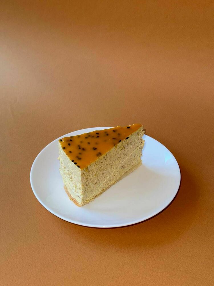 Nutty cheesecake with mango passion fruit sauce