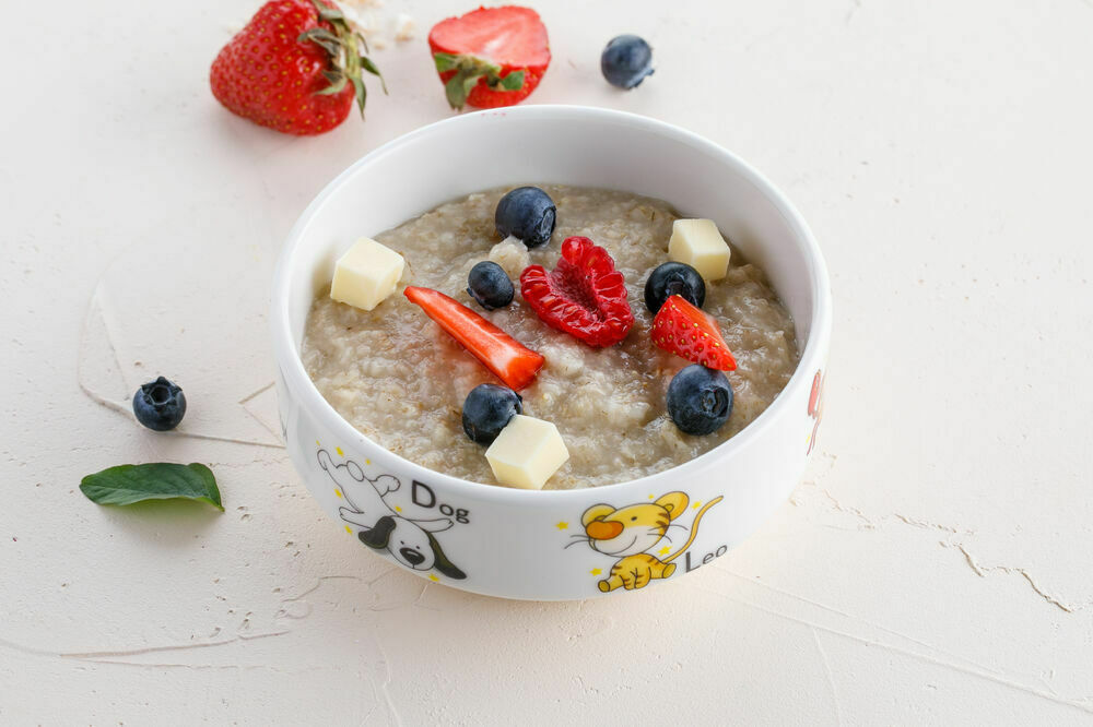 Oatmeal porridge with berries on water