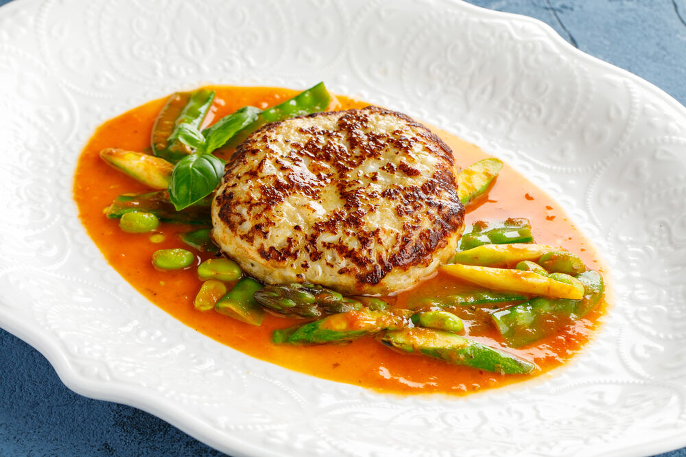 Fish cutlet with young vegetables and Bisque sauce