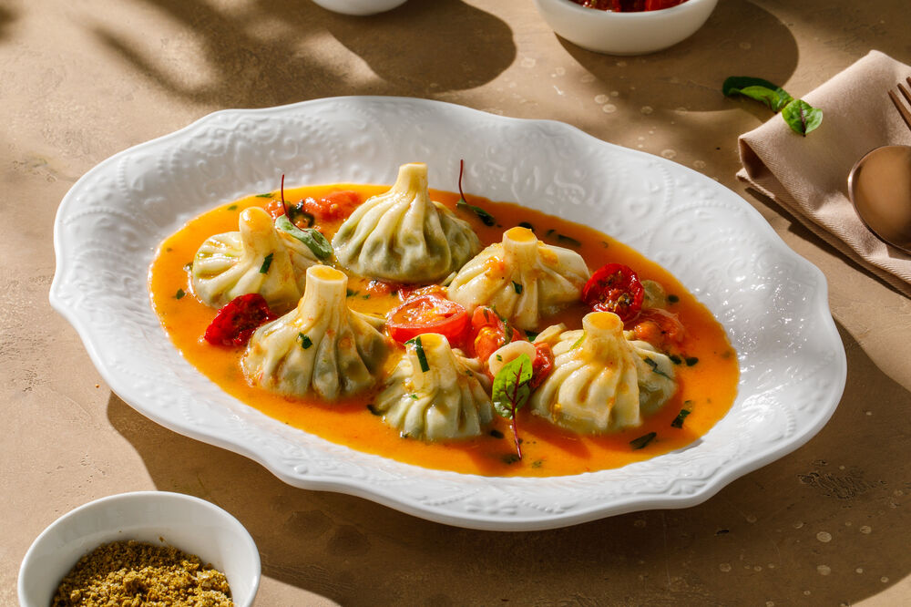 Mini khinkali with nadugi and fresh tomato sauce