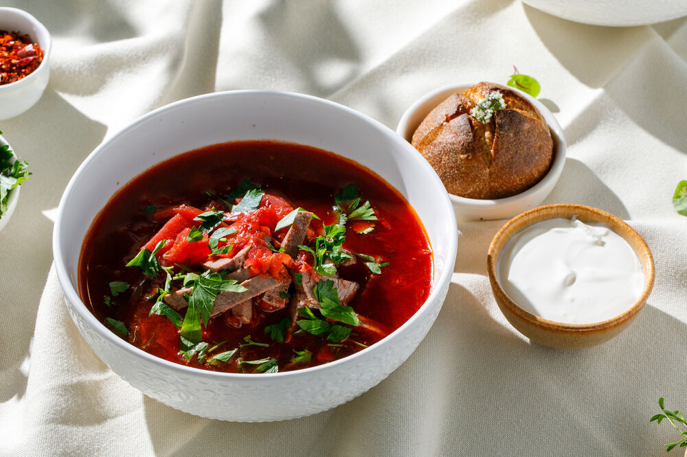 Homemade borscht with sour cream