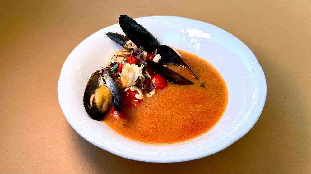 Soup with seafood and cherry tomatoes