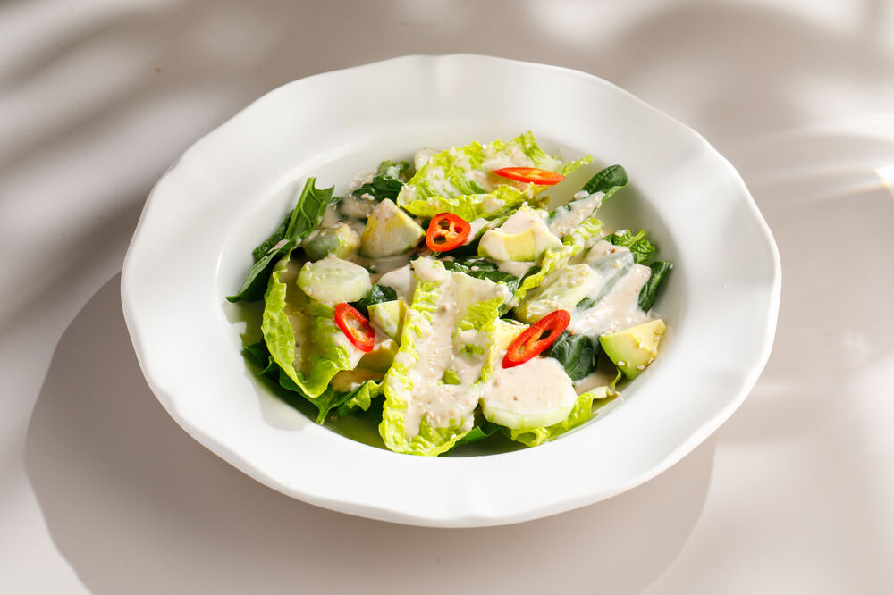 Green salad with nut sauce and avocado
