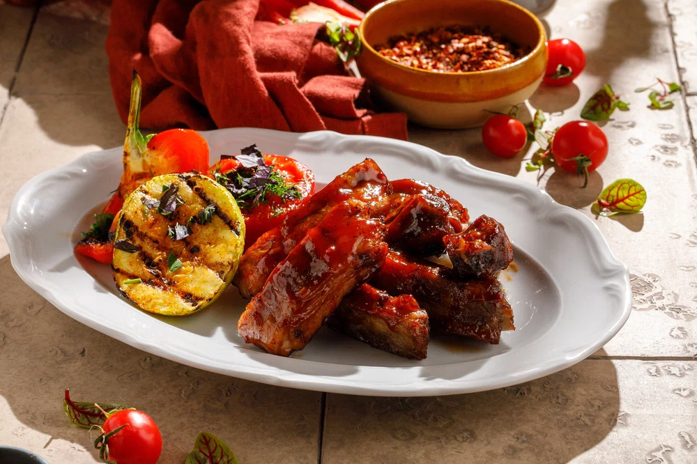 Griilled pork ribs with BBQ sauce and grilled vegetables