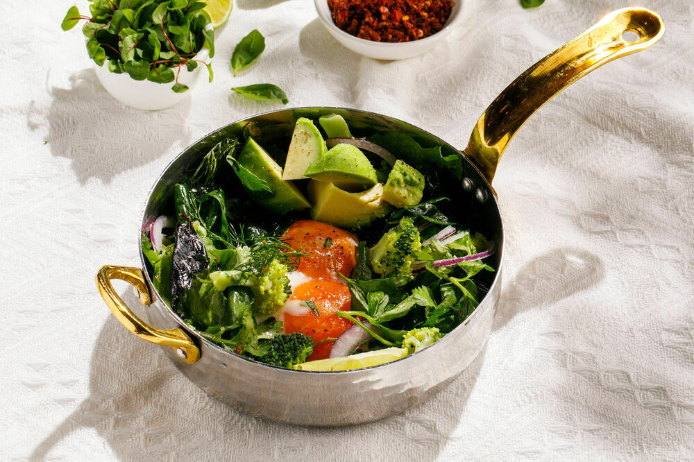 Aromatic fried eggs with spiced fresh greens and avocado