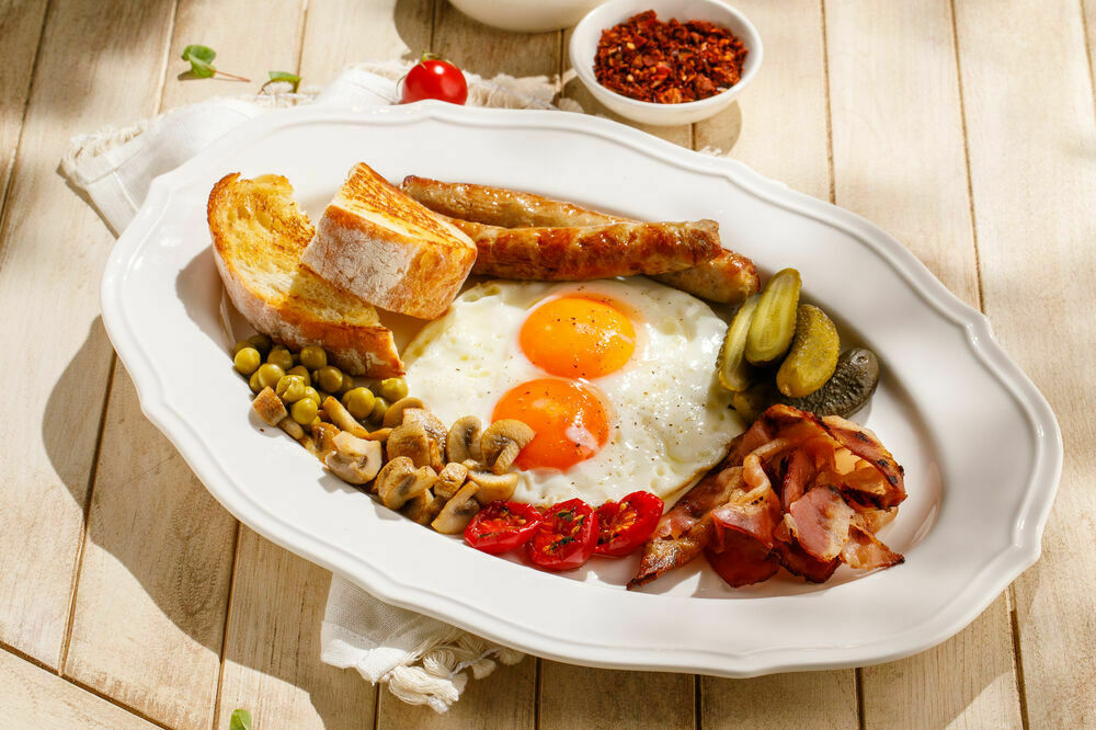Sunny-side up eggs with sausage and bacon
