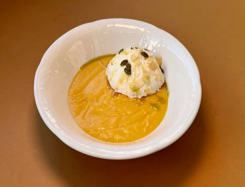 Pumpkin cream soup with coconut mousse
