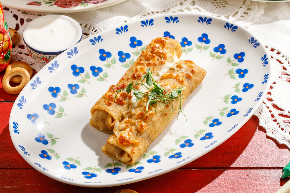Baked pancakes with mushrooms and cheese