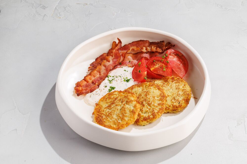 Pancakes with bacon, tomatoes and spicy sauce