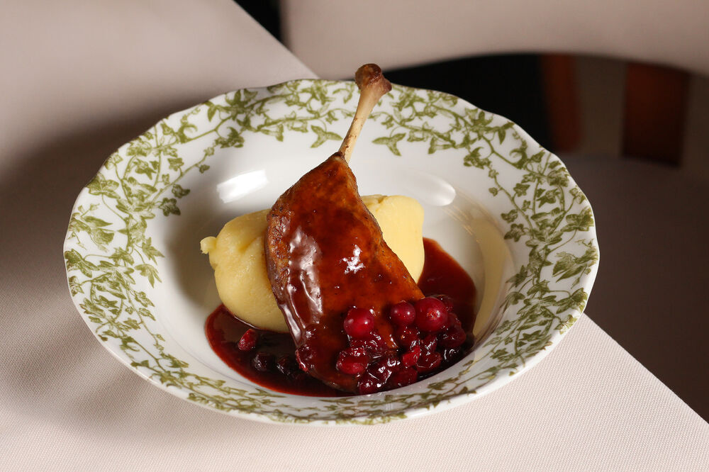Duck leg confit with mashed potatoes and wild berry sauce