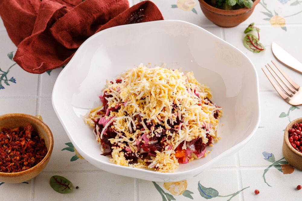 Dressed salad under herring