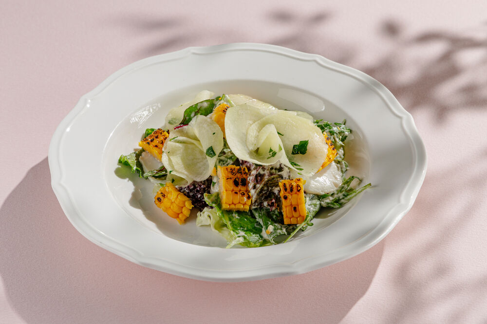 Green salad with squid, corn, and pickled radish