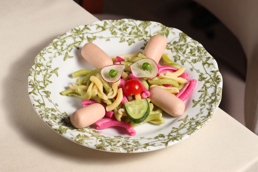 Colored pasta with sausages