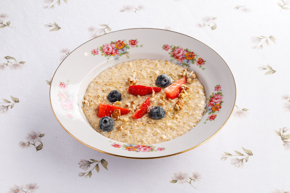Oatmeal porridge with melted milk and seasonal berries