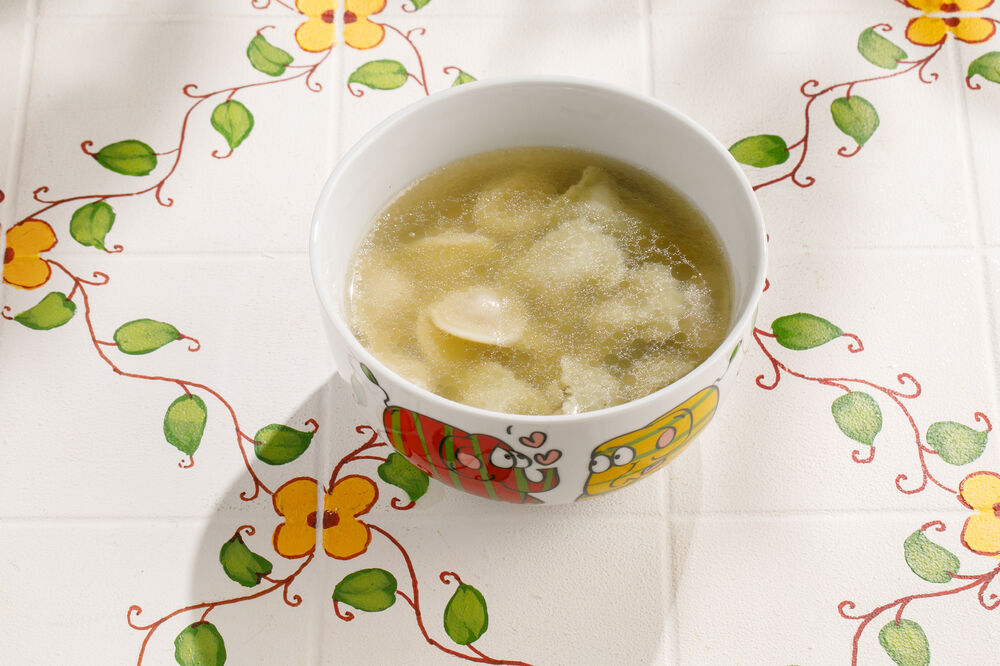 Baby chicken broth with colored chicken ravioli