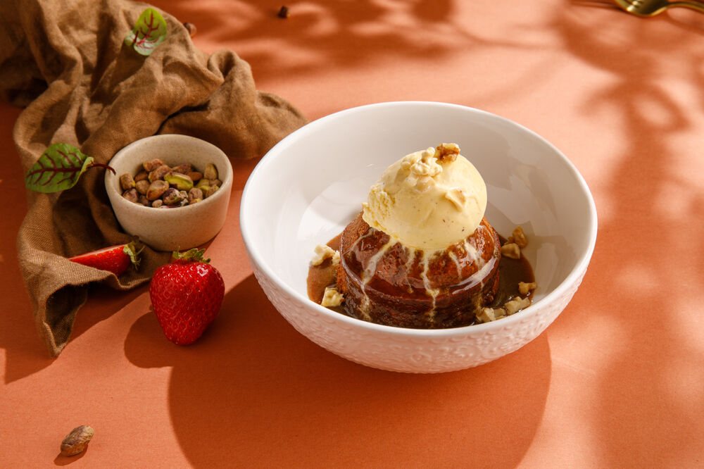 Date cake with vanilla ice cream