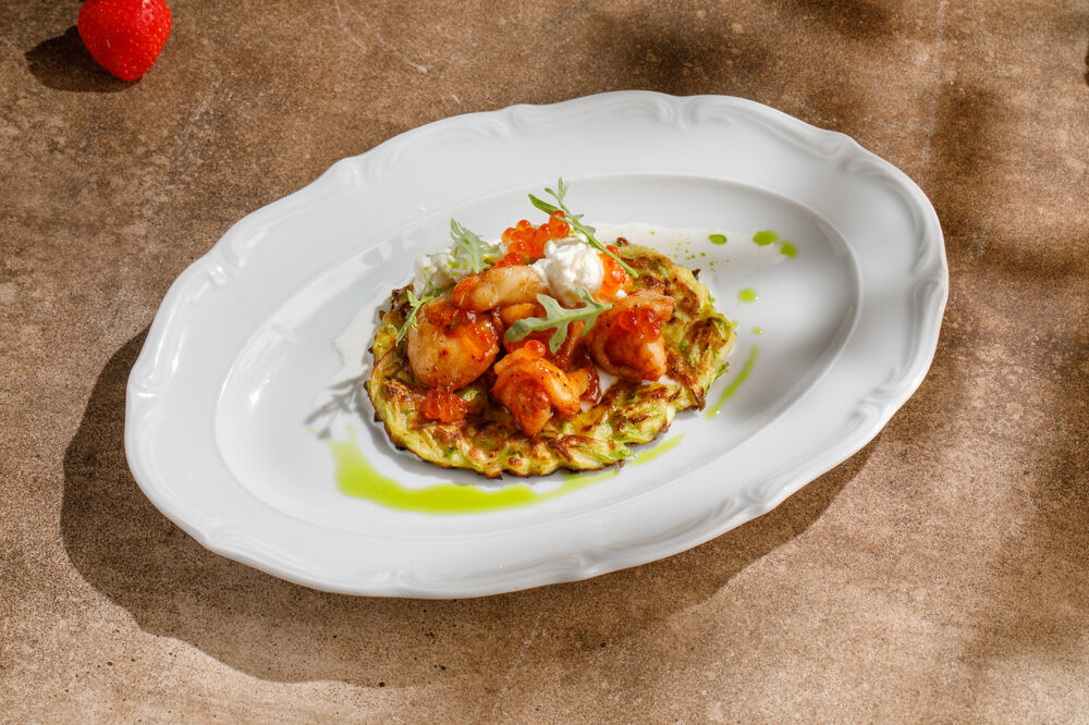 Zucchini pancakes with shrimp, stracciatella, and red caviar
