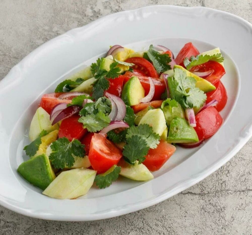 Homemade Italian saladwith ripe tomatoes and avocado