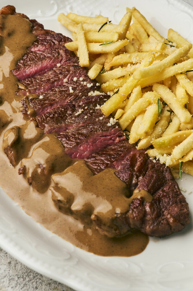 Striploin with pepper sause and parmesan fries