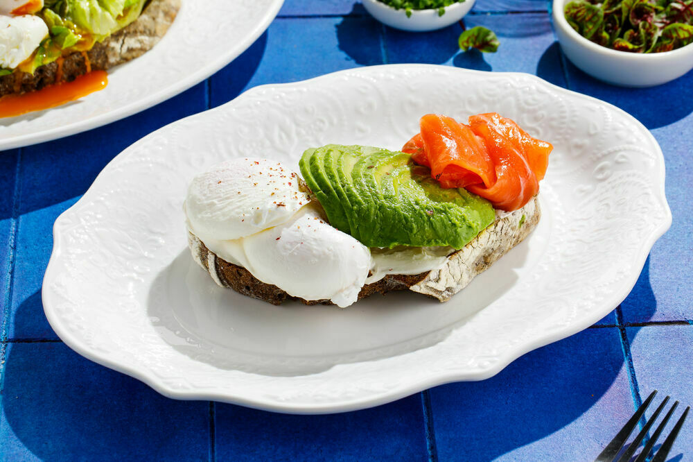 Poached egg on a toast with salmon and avocado