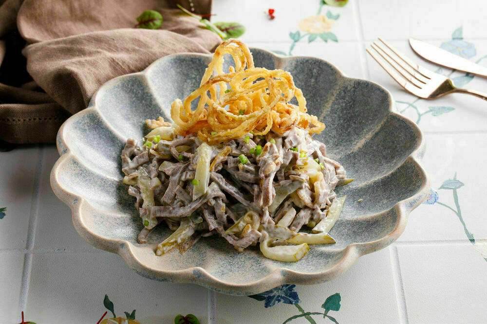 Beef tongue salad with pickled cucumbers
