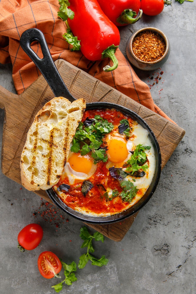 Shakshuka in butter with tomatoes and basil