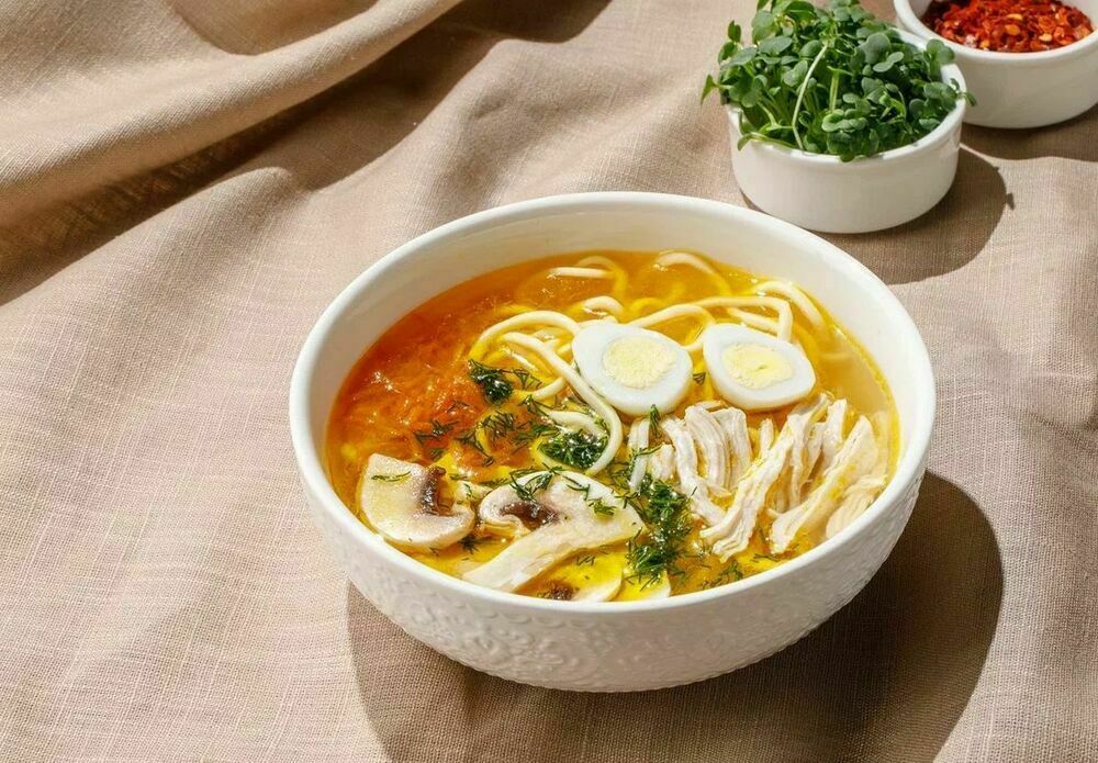Homemade noodle soup with chicken and mushrooms