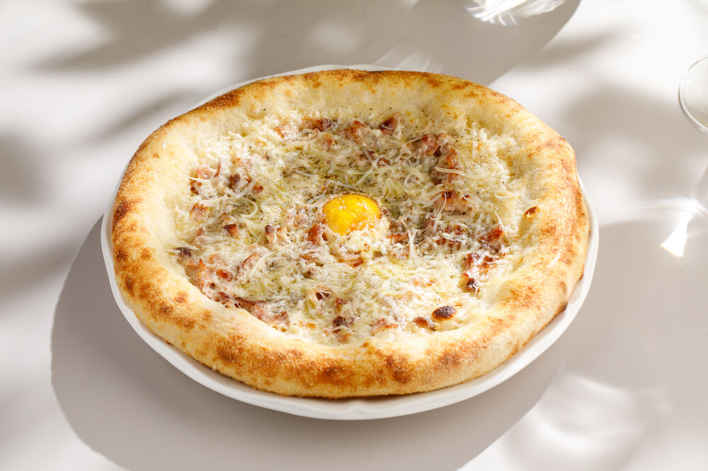 Pizza with egg and bacon