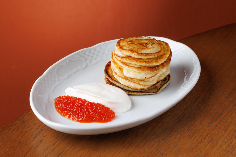 Pancakes with red caviar and sour cream