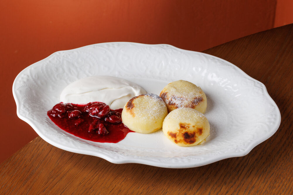 Syrniki with berry jam and sour cream