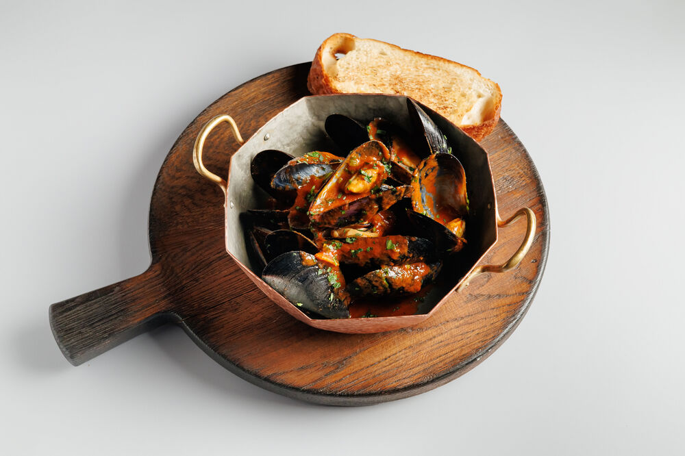 Black Sea mussels in tomato sauce with red adjika