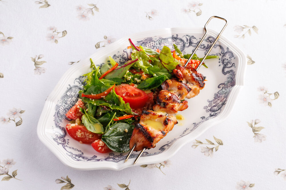 Charcoal-grilled chicken salad with couscous and tomatoes