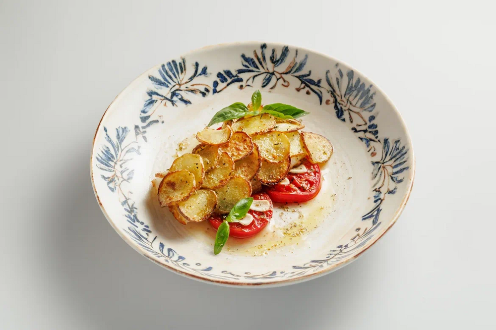Sea bass with potatoes and baked tomatoes