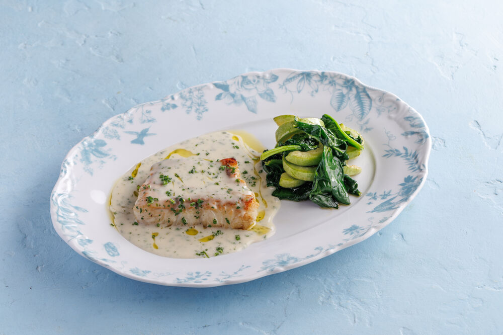 Pike perch fillet with sauce and sautéed zucchini and spinach