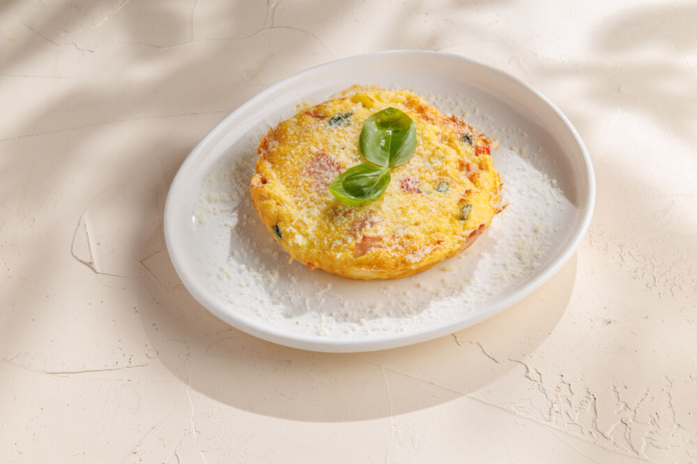 Frittata with ham, tomatoes, Parmesan, and basil