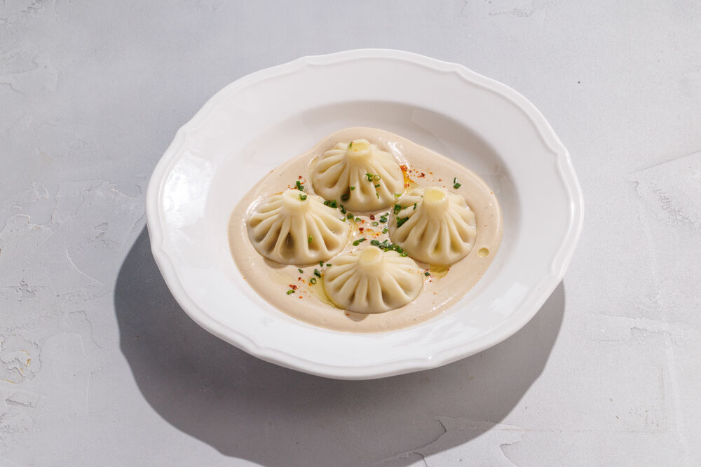 Mini khinkali in pepper sauce with cheeks