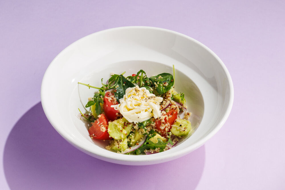 Salad with fresh vegetables, quinoa, and stracciatella