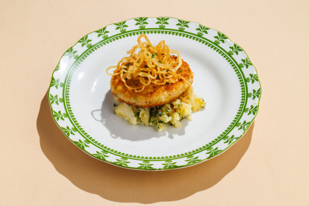 Fried fish cutlet with mashed potatoes and fried onions