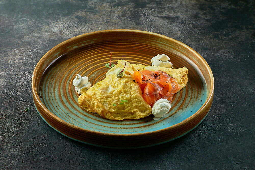 Breakfast omelet with a smoked salmon and sauce cream-cheese