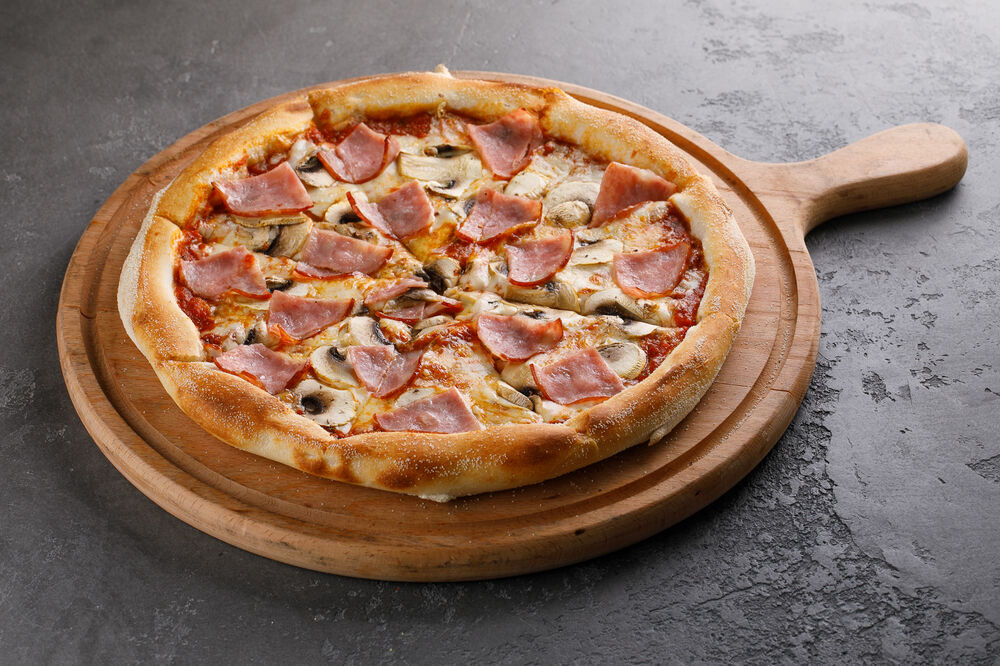 Pizza with ham, mushrooms and olives
