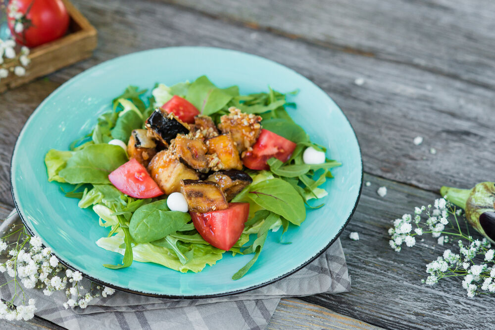 Salad with fried eggplants, tomatoes and yogurt spheres