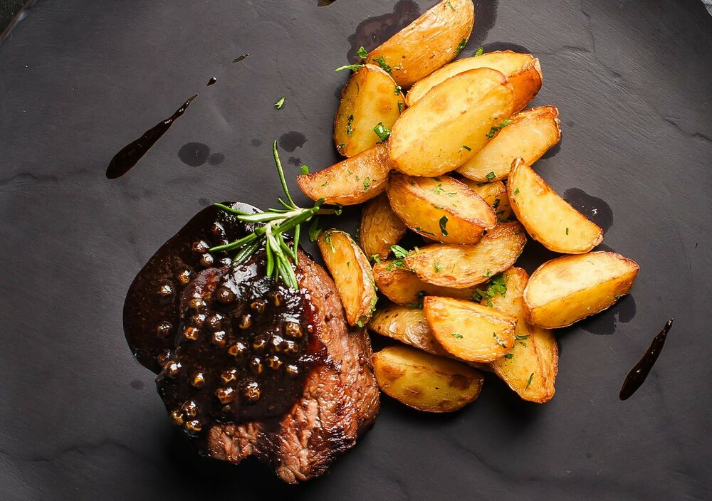 Roast beef with pepper sauce and baked potatoes on promotion